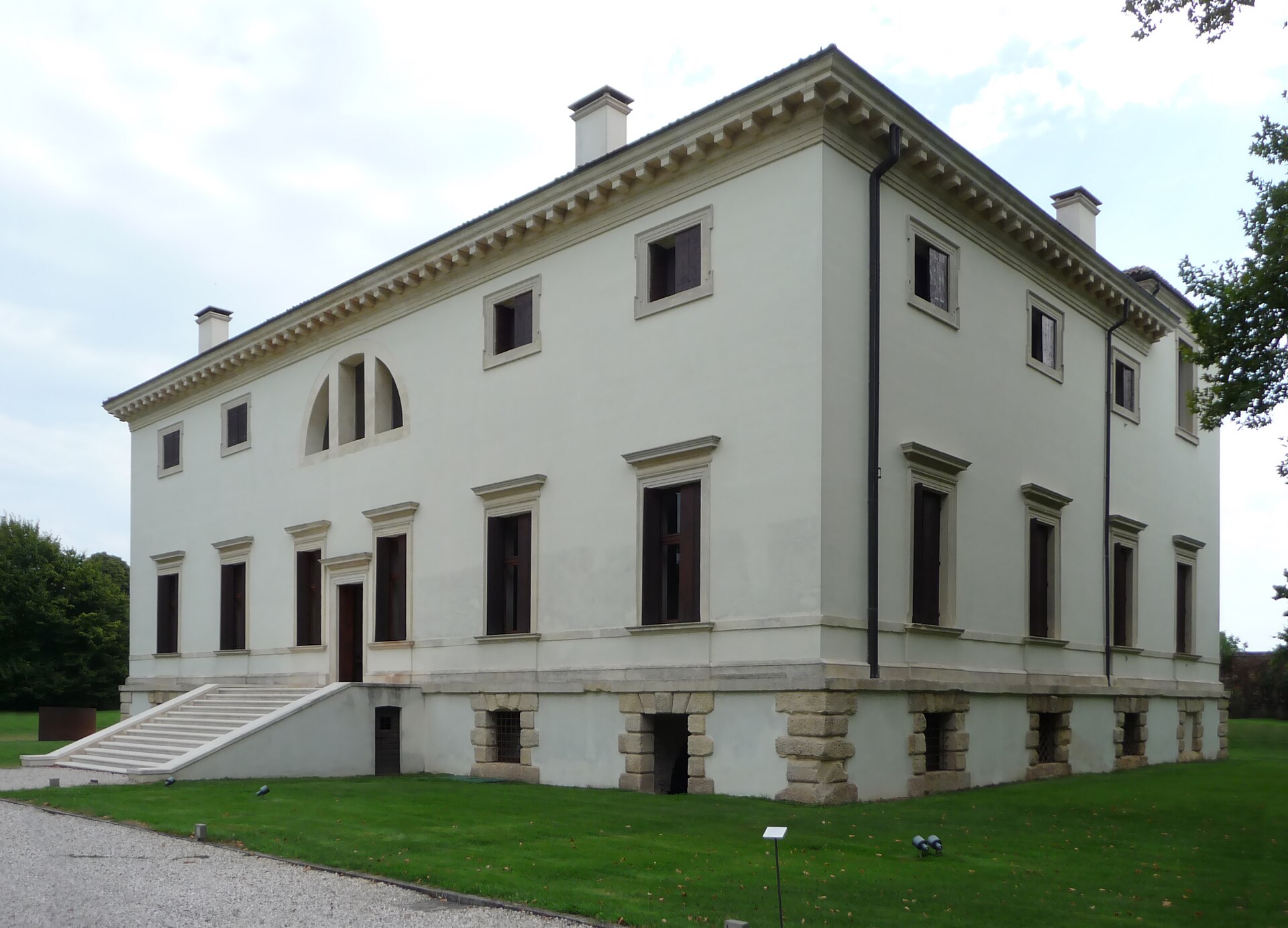 The façade of a historic listed Venetian villa, with an entrance stairway and a thermal window